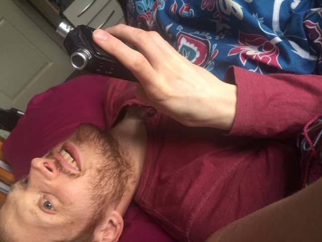 photo of David in bed with microphone