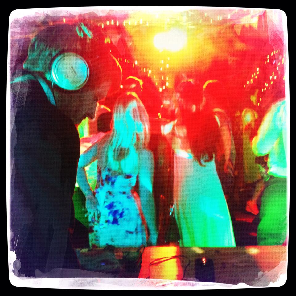 Photo of David DJing with people dancing